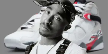 Black-and-white portrait of Tupac Shakur in a bandana, with a pair of retro sneakers blurred in the background