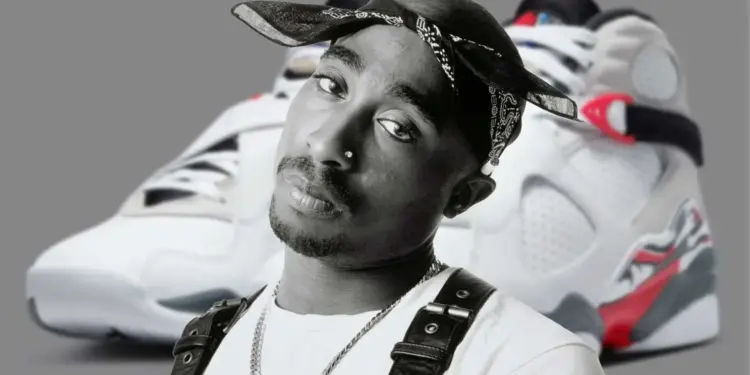 Black-and-white portrait of Tupac Shakur in a bandana, with a pair of retro sneakers blurred in the background